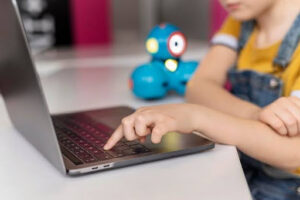 Child learning internet safety skills while using a laptop