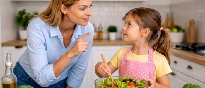 child helping prepare food safely with parent in kitchen